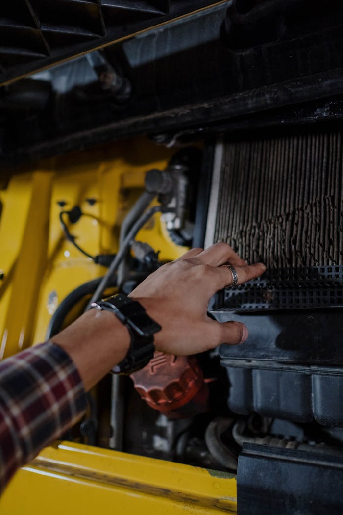 Crafting Captivating Headlines: Your awesome post title goes here Close-up of a hand inspecting a truck's engine air filter. Mechanical maintenance concept.